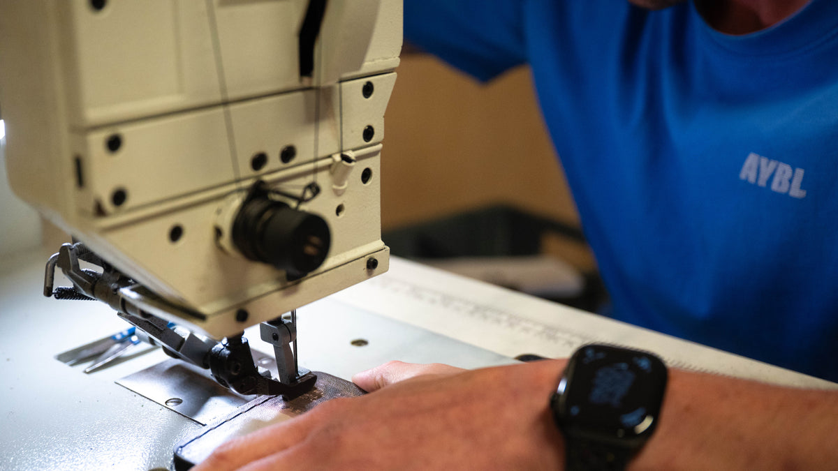 A leather lifting belt being sewn in the ModiFit workshop